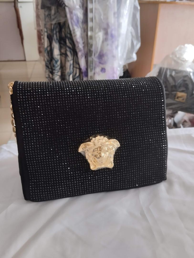 Versace bag,  comes in various colours. Red. Gold. Black. Silver